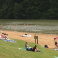 Lots of people at Strouds Run State Park enjoying the beach and water attractions.